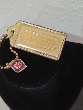Coach Gold Leather Hangtag with Pink Dried  Floral Charm